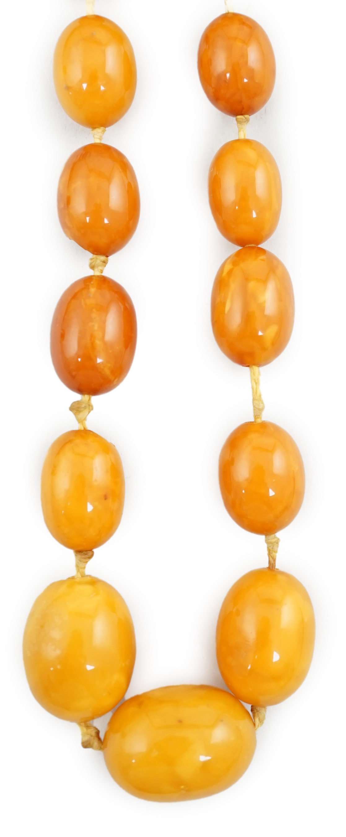 A single strand graduated oval amber bead necklace